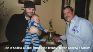 J D'Andria With a Trophy With his Family at his Home