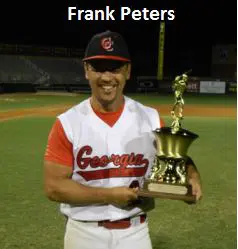 Frank Peters Holding a Trophy on a Field