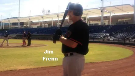 Jim Frenn on a Field Holding a Bat