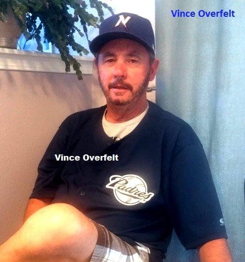 Vince Overfelt in a Baseball Cap Sitting
