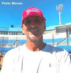 Peter Moran in a White Shirt Red Cap