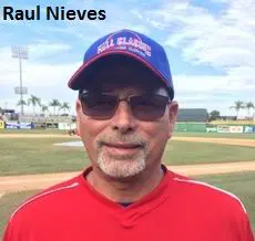 Raul Nieves in a Red Color Top Smiling Portrait