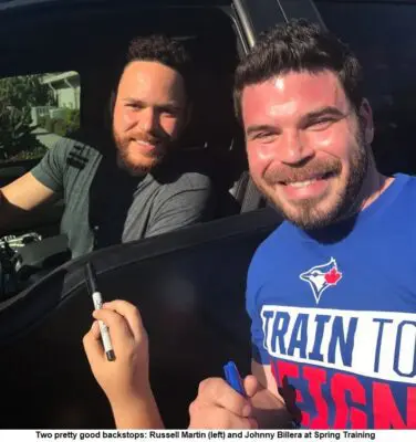 A Man in a Blue Color Top Standing Beside a Man in a Car