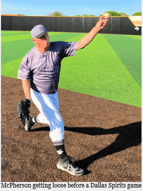 A Man in a Grey Color Top on a Baseball Field