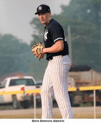 A baseball player standing on a field with a gloves.