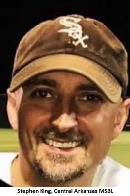 Smiling man wearing a baseball cap.