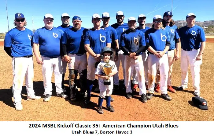 A baseball team photo of the utah blues, winners of the 2024 msbl kickoff classic 35+ american champion, posing on a dusty field with a child and trophies in front.