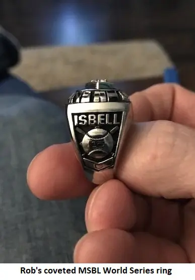 A hand holding a msbl world series ring with the name "isbell" and the year 1988 engraved on it.