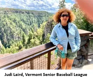 Woman standing by scenic forest view.