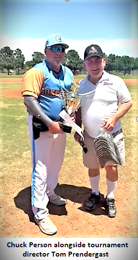 Two men holding a trophy on field.