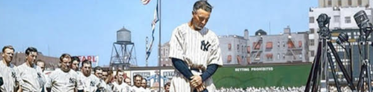 Baseball player standing with teammates, speaking.
