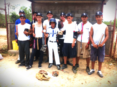 Baseball team posing with bats and gloves.